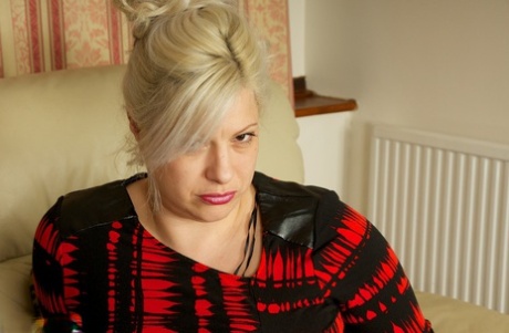 Mature BBW Gina George uncorks her saggy tits before masturbating on couch