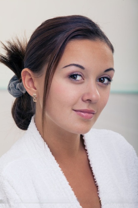 Wet European babe exposing small teen breasts and shaved cunt in bathtub