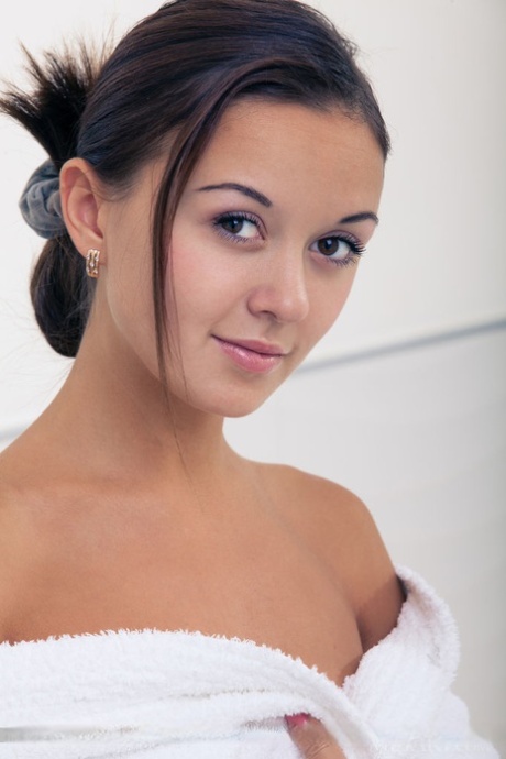 Wet European babe exposing small teen breasts and shaved cunt in bathtub