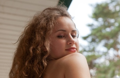 Pretty girl Wanda naked on the balcony boldly showing a hairy snatch