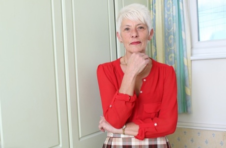 Over 70 Bristish granny takes off her clothes and lingerie striptease style