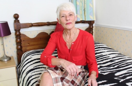 Over 70 Bristish granny takes off her clothes and lingerie striptease style