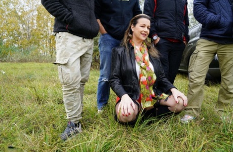 Horny granny Eva Jayne gets cum on her face after a gangbang in a field