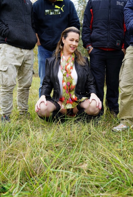 Horny granny Eva Jayne gets cum on her face after a gangbang in a field