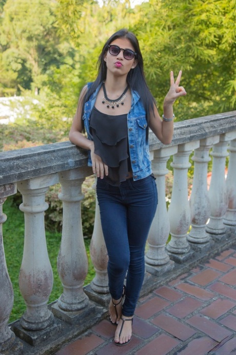 Brazen Denisse Gomez hangs out on the patio in sheer pantyhose and white thong