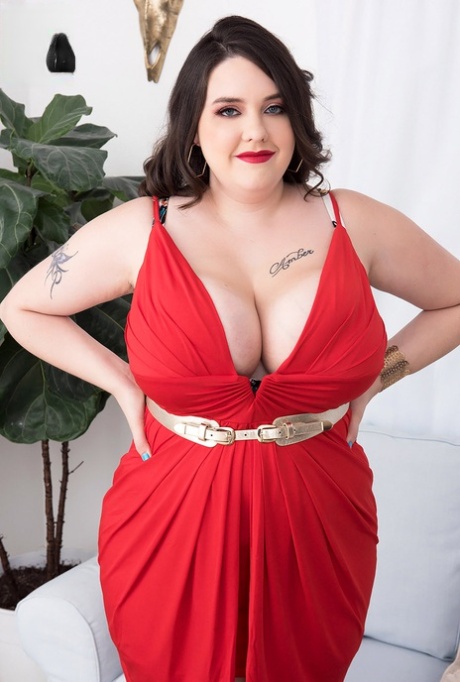 Tattooed BBW Nagini unleashes her giant tits as she takes off a red dress