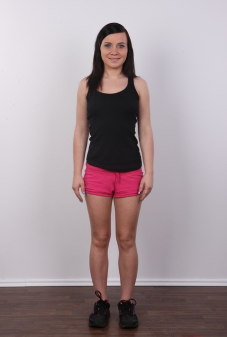 First timer with brunette hair uncovers her pierced pussy after getting naked