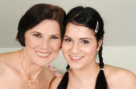 Young and mature lesbian babes with tiny tits show their naked bodies