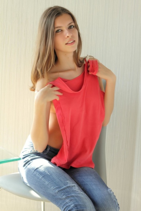 Brunette beauty Ksenee shows her big ass and poses naked on a chair