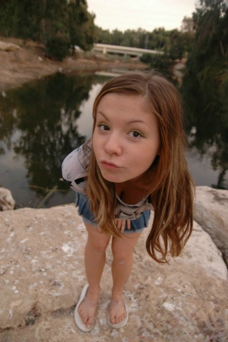 Charming young girl uncovers her tiny tits during upskirt action