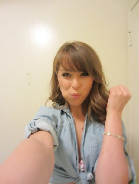 Clothed teen Riley Reid does some sexy self shots while in a toilet