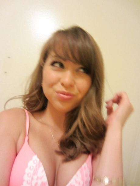 Clothed teen Riley Reid does some sexy self shots while in a toilet