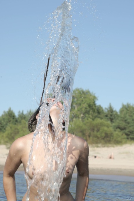 Sexy babe Alice D strips naked and shows off her trimmed pussy outdoors