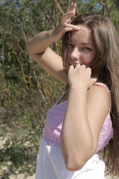 Sexy babe Alice D strips naked and shows off her trimmed pussy outdoors