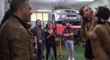 Skinny Tina Kay & busty MILF Susy Gala enjoy bondage action in a car workshop