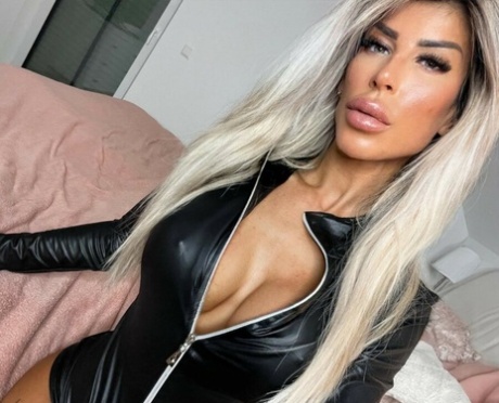 Tattooed amateur teases with her stunning curves in hot outfits