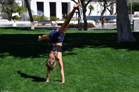 Cute blonde Athena does a cartwheel in shorts during non-nude action in public