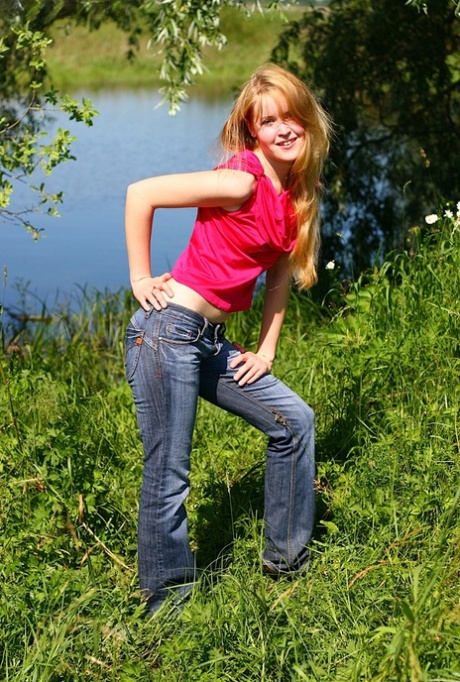 Skinny young amateur Alina sheds jeans & cotton panties outdoors to pose naked