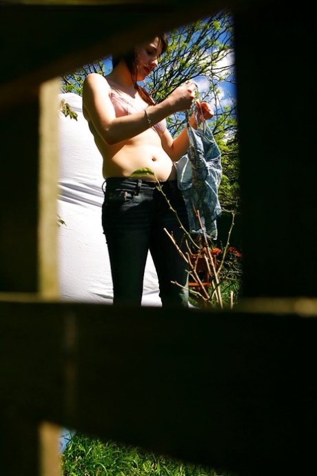 Hidden voyeur spies on naked girl getting dressed outdoors