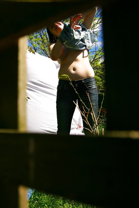 Hidden voyeur spies on naked girl getting dressed outdoors