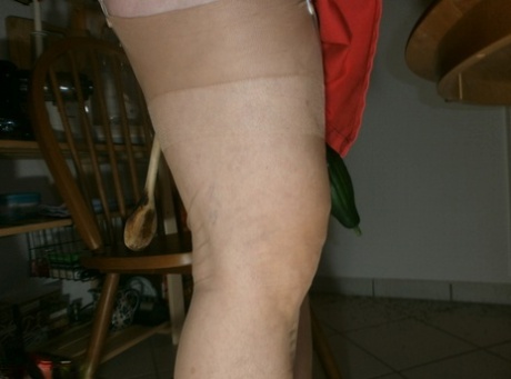 Horny oma Caro pleasures her pussy with a wooden spoon and a cucumber