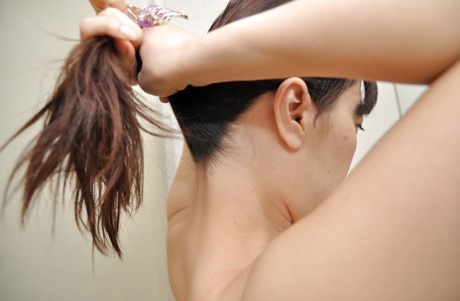 Asian brunette with small tits Yoshie washing her pussy