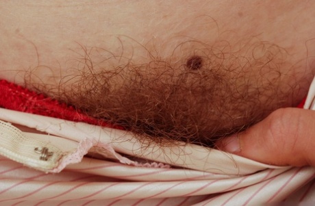 Gorgeous ginger Valcorie squats to show her hairy red pussy close up