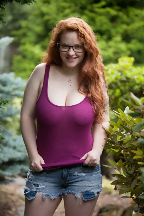 Natural redhead teen exposes her thick body and big saggy boobs in the woods