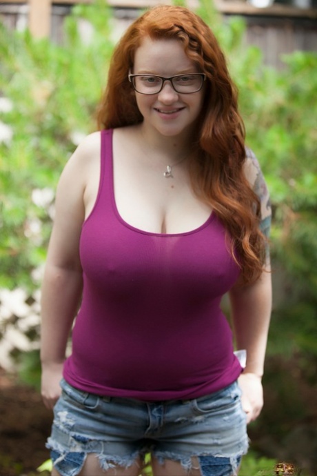Natural redhead teen exposes her thick body and big saggy boobs in the woods