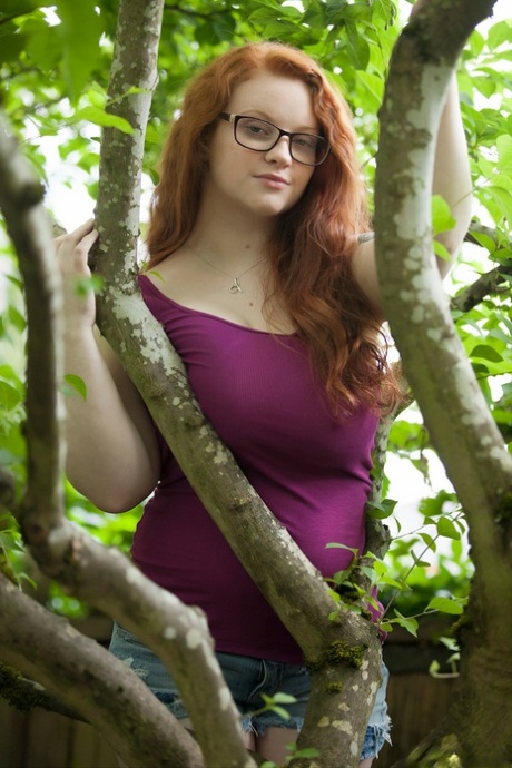 Natural redhead teen exposes her thick body and big saggy boobs in the woods