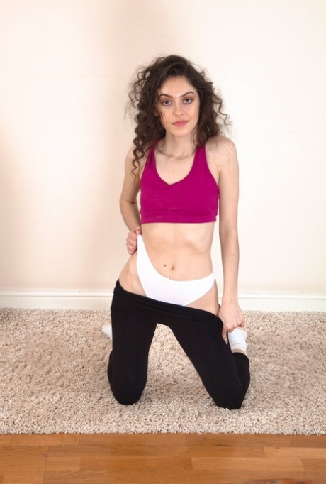 Slim brunette uncovers her tiny tits before showing her full bush