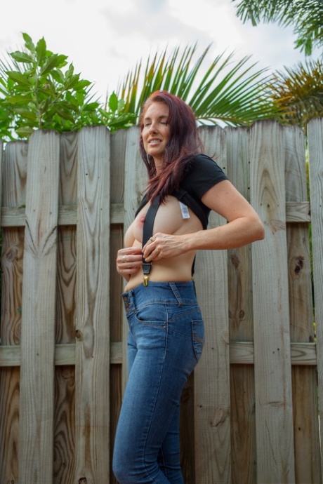 Hot redhead Andy Adams loses her t-shirt & jeans in the yard to pose naked
