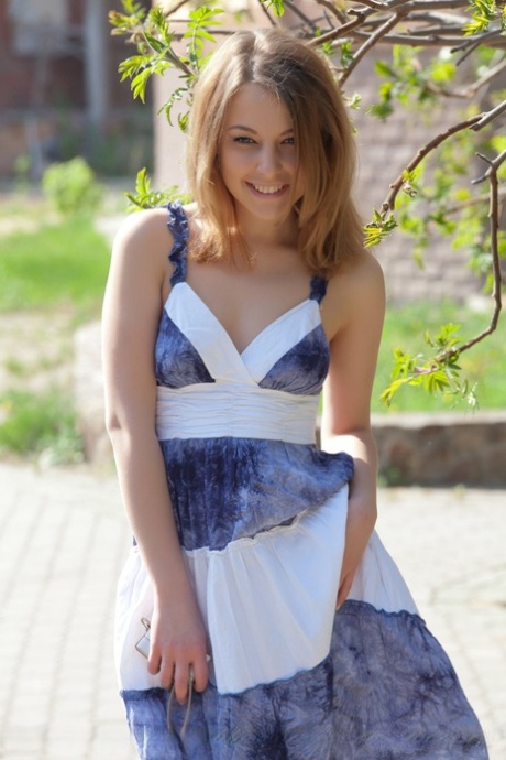 Smiley faced teen Nikia A removing dress for outdoor glamour spread